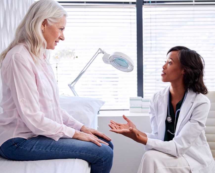 A woman doctor talking to her woman patient while sitting