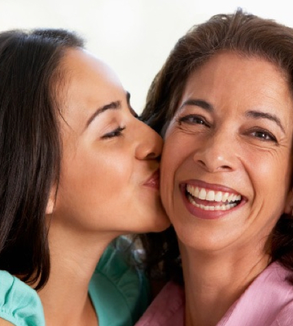 A picture of daughter kissing her mother together with a testimonial