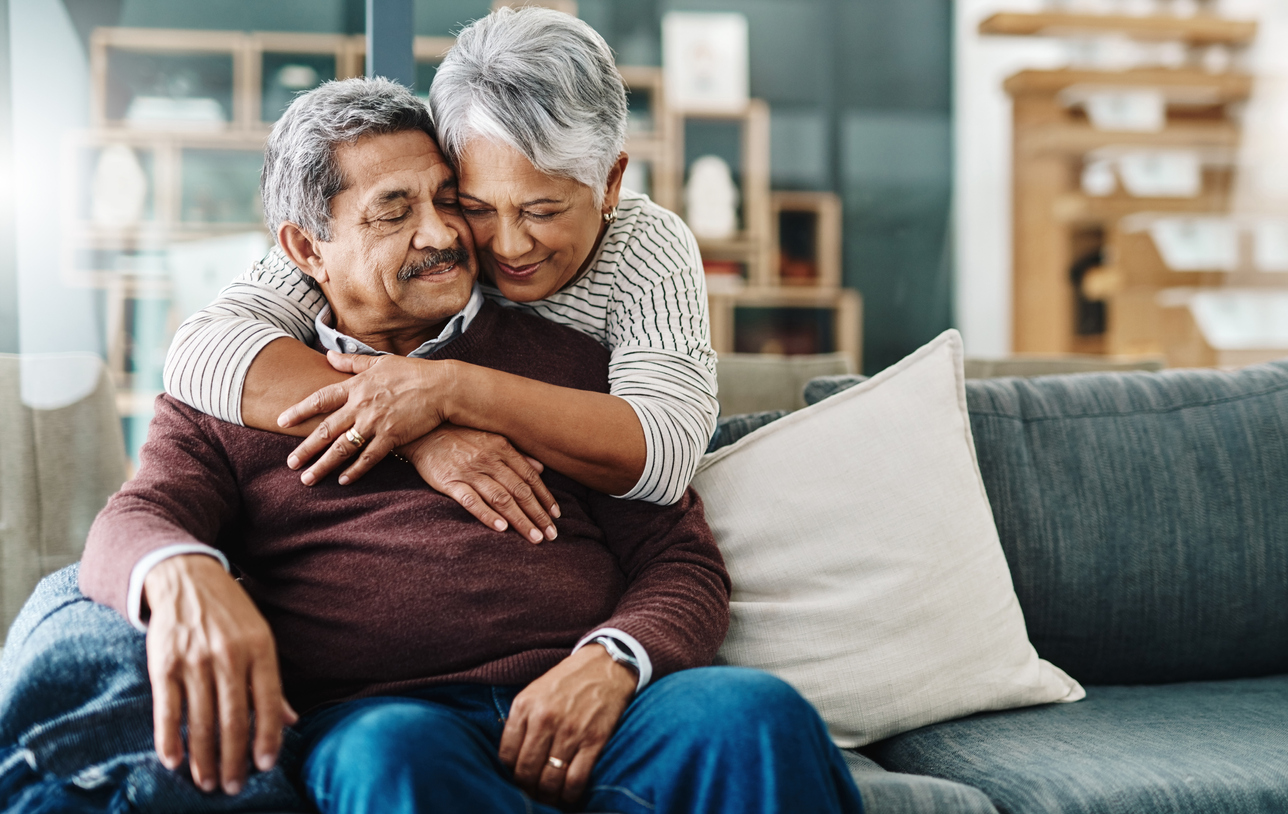 A happy elderly couple hugging each other