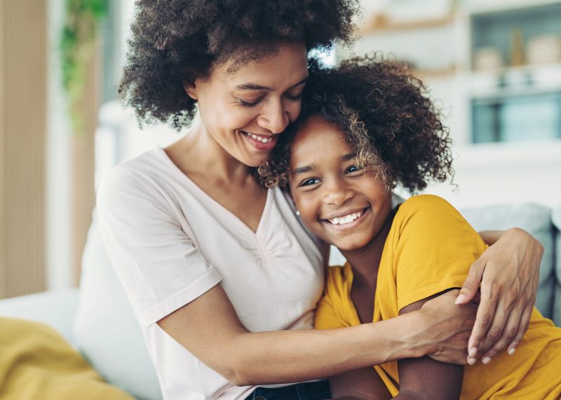 Smiling mother embracing her daughter